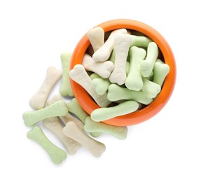 Photo of Different bone shaped dog cookies and feeding bowl on white background, top view