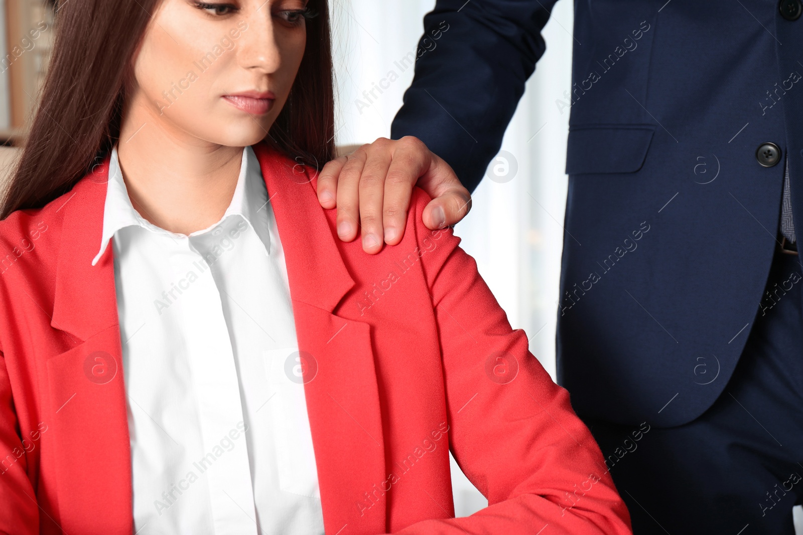 Photo of Boss molesting his female secretary in office, closeup. Sexual harassment at work