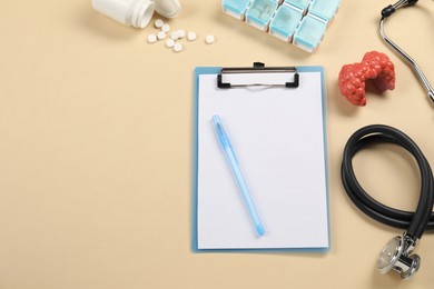 Endocrinology. Flat lay composition with clipboard and model of thyroid gland on beige background, space for text