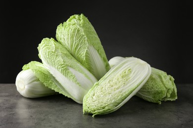 Photo of Fresh ripe Chinese cabbages on grey table