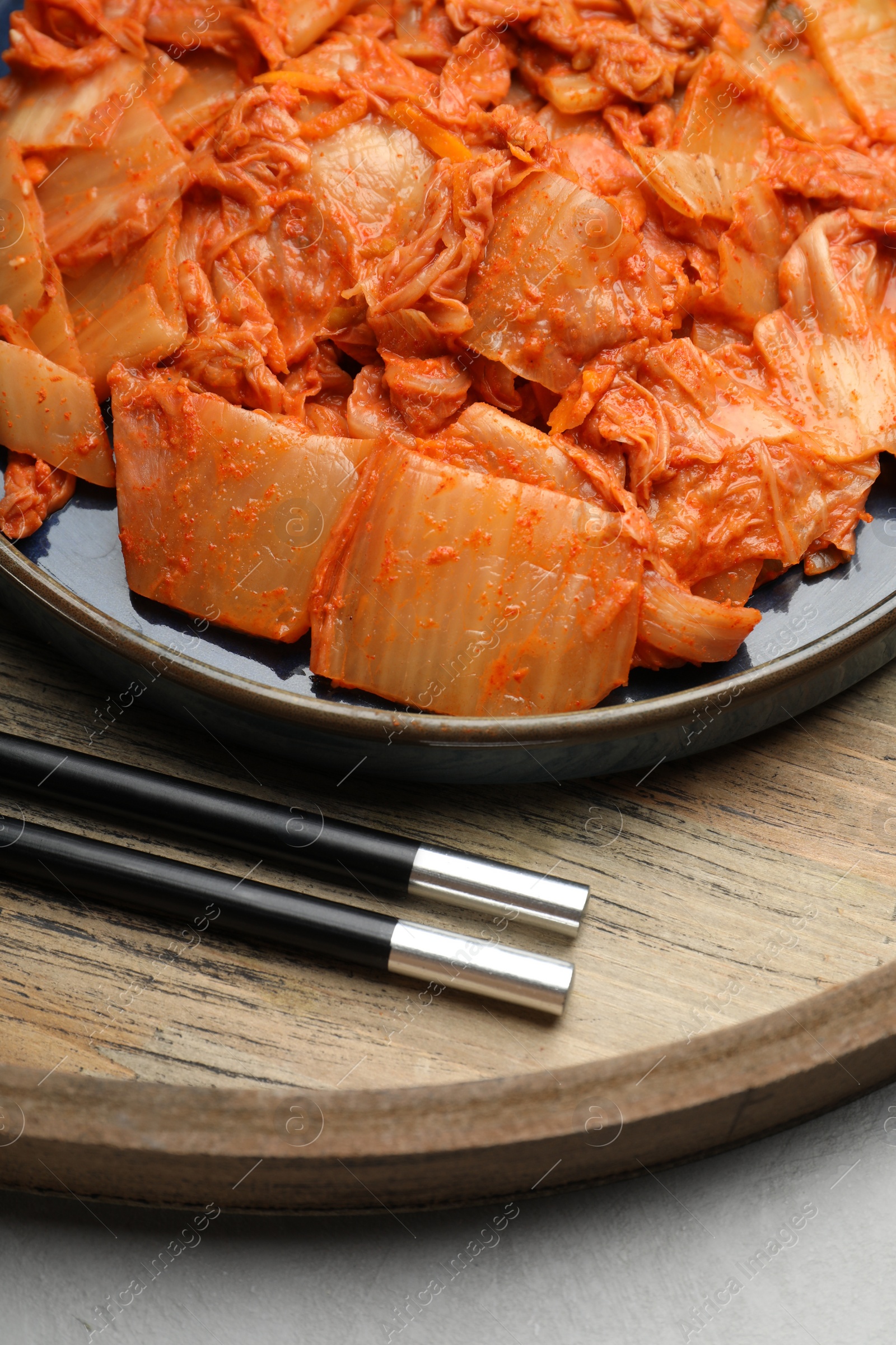 Photo of Delicious kimchi with Chinese cabbage on white table, closeup