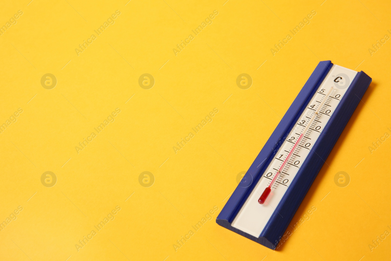 Photo of Weather thermometer on yellow background. Space for text