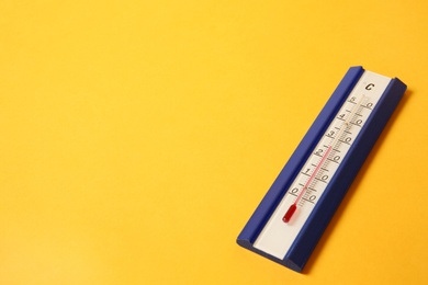 Photo of Weather thermometer on yellow background. Space for text