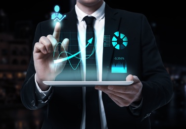 Image of Business analytics. Man working with modern tablet, closeup