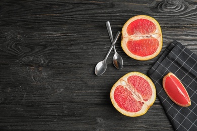 Photo of Flat lay composition with grapefruits and space for text on dark wooden background