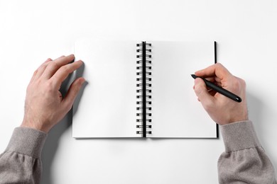 Photo of Man with pen and empty notepad on white background, top view