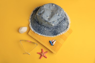 Photo of Flat lay composition with beach accessories on orange background