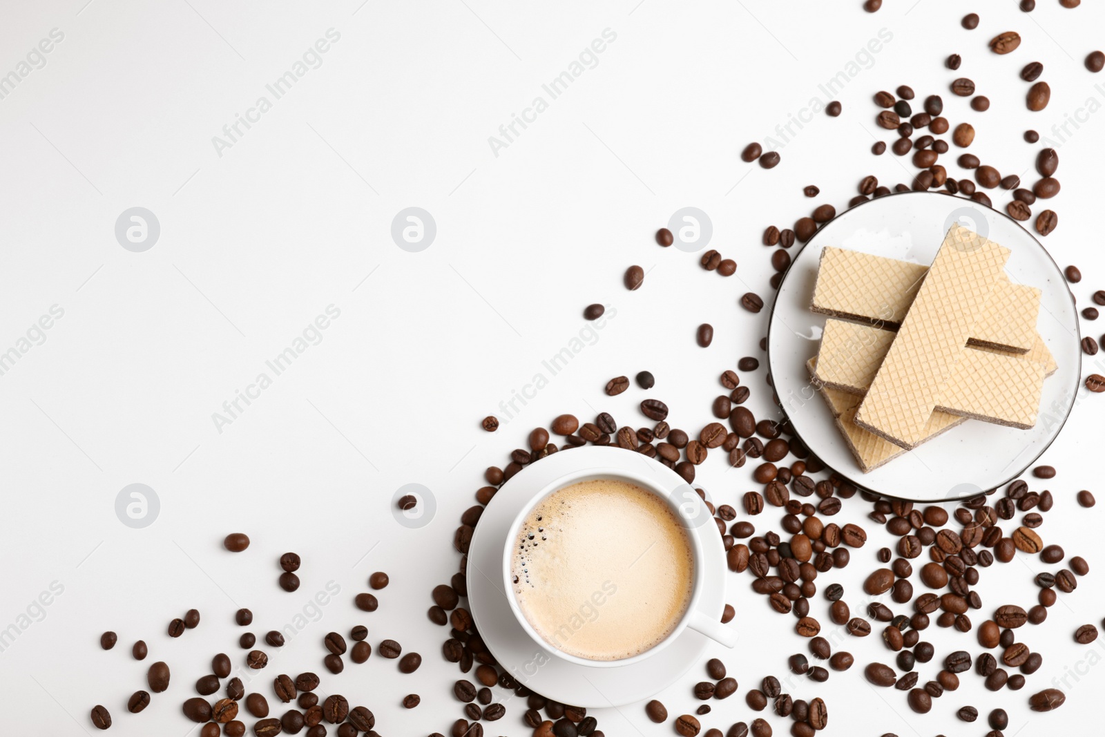 Photo of Breakfast with delicious wafers and coffee on white background, flat lay. Space for text