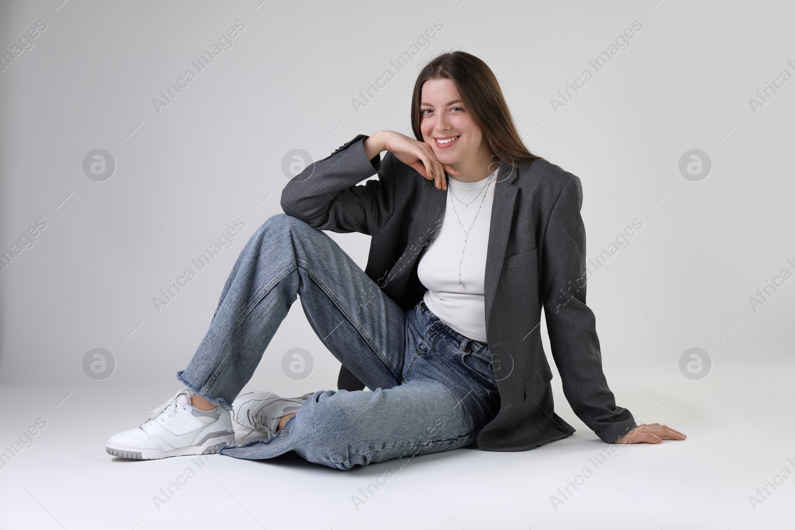 Photo of Portrait of beautiful young woman on light grey background