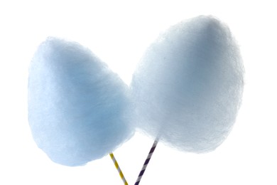 Photo of Sticks with yummy cotton candy isolated on white