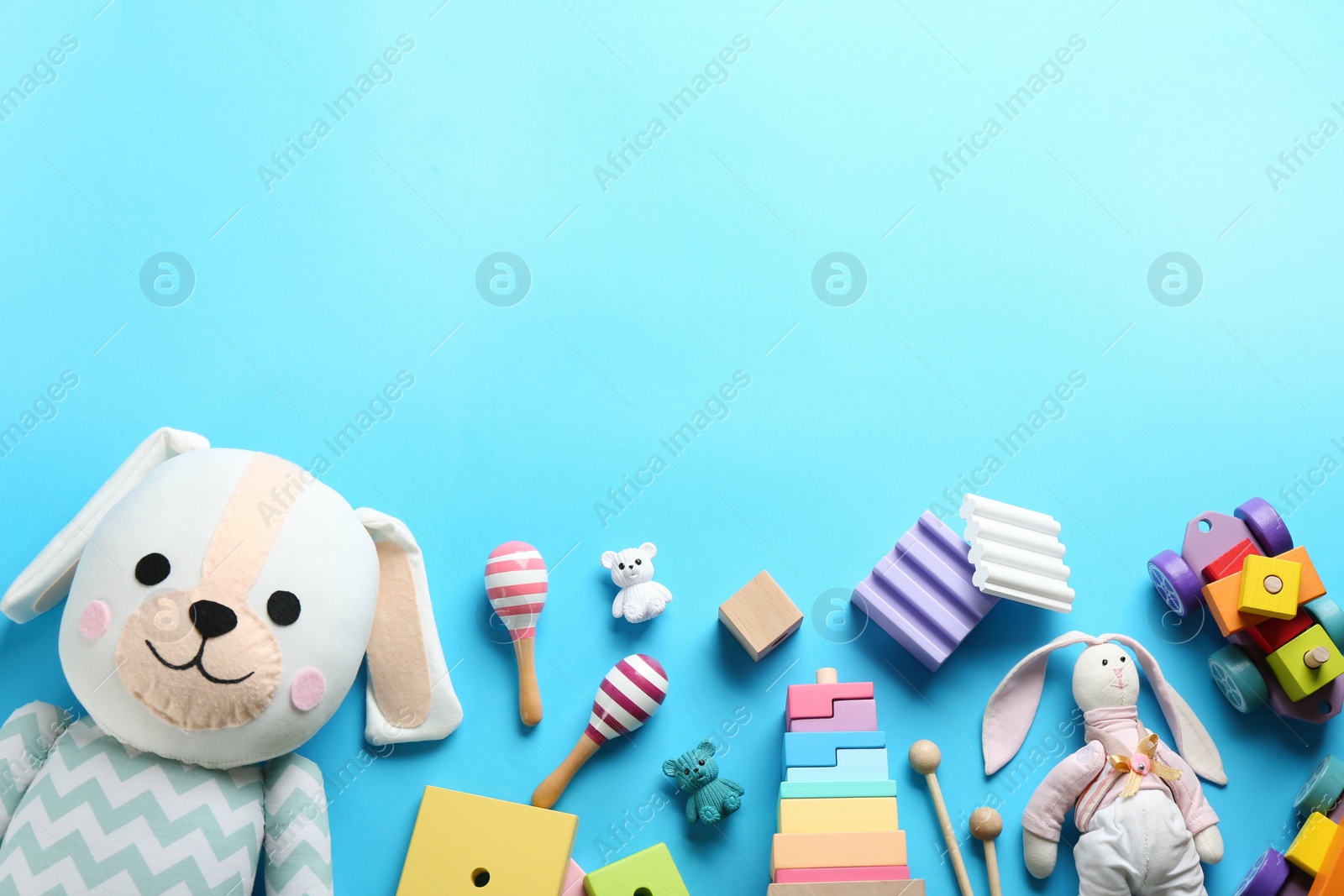 Photo of Flat lay composition with different toys on light blue background. Space for text