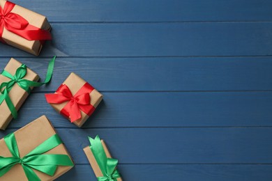 Photo of Many gift boxes on blue wooden table, flat lay. Space for text