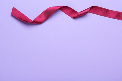 Photo of Beautiful ribbon on light background, top view. Space for text