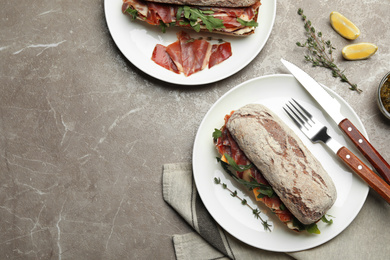 Flat lay composition with delicious sandwich on marble table. Space for text