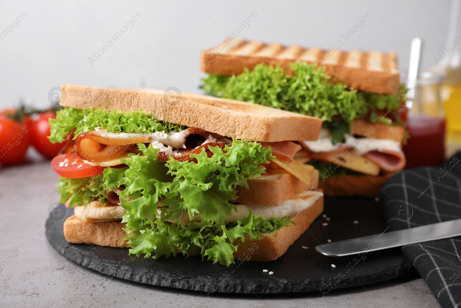 Photo of Freshly made sandwiches served on grey table