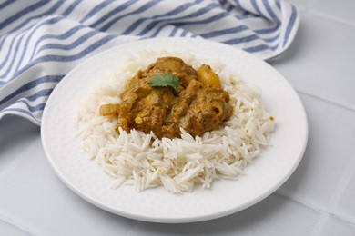 Photo of Delicious chicken curry with rice on white tiled table