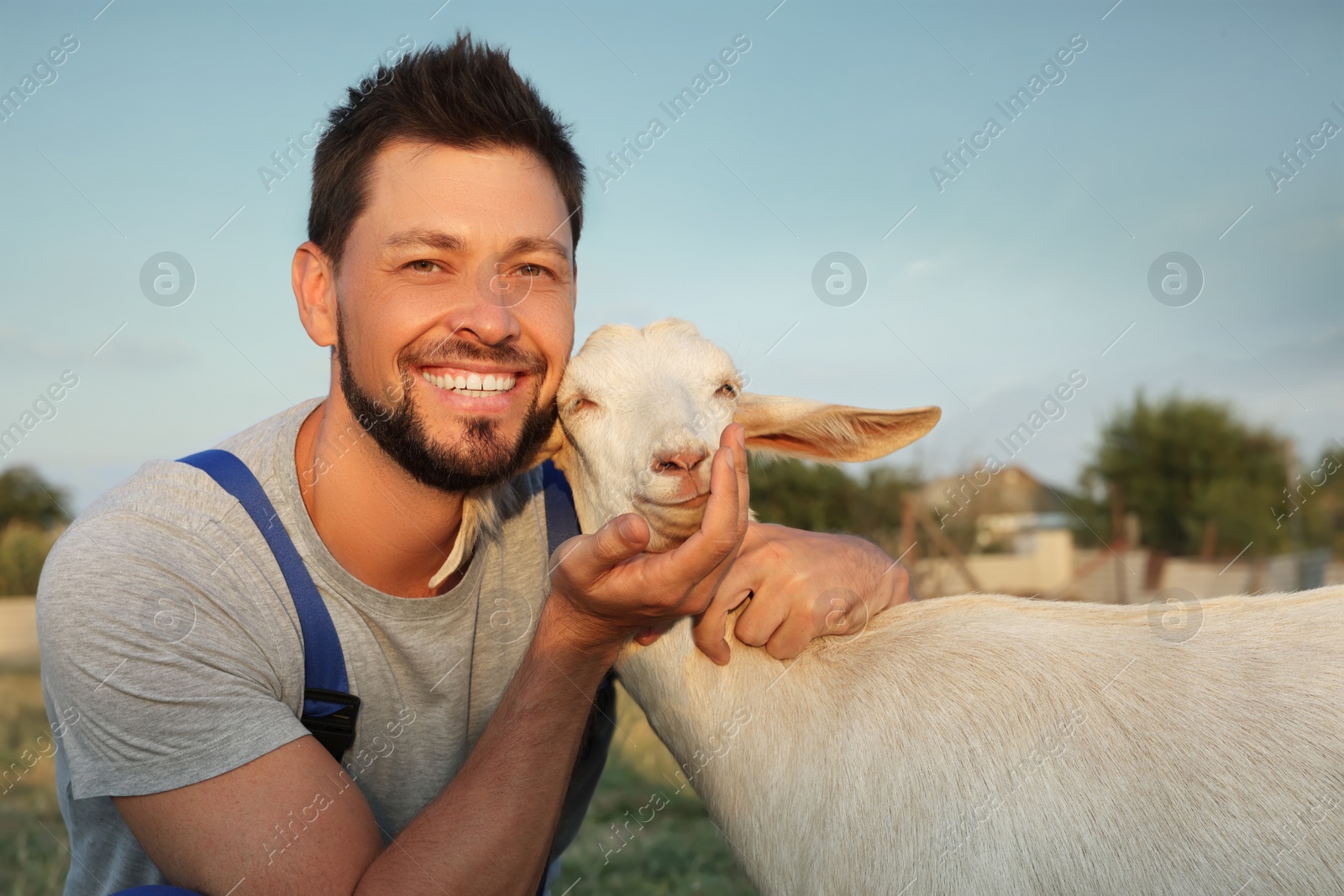 Photo of Man with goat at farm. Animal husbandry