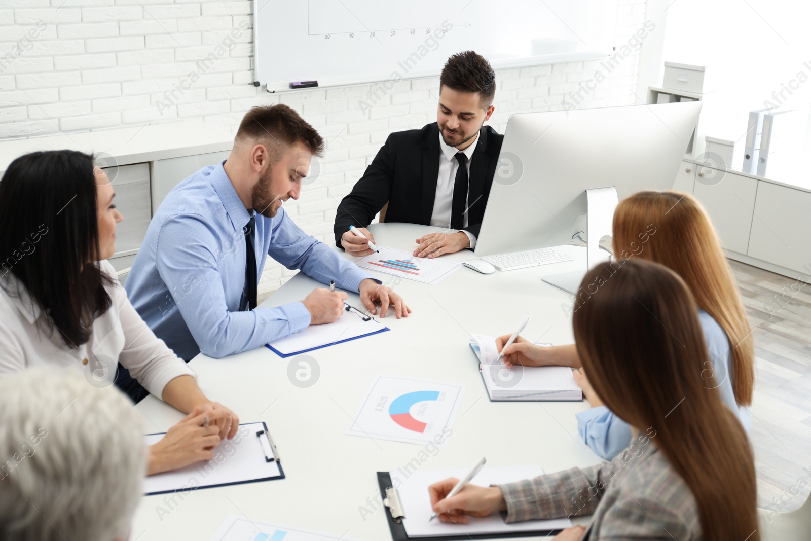 Photo of Professional business trainer working with people in office