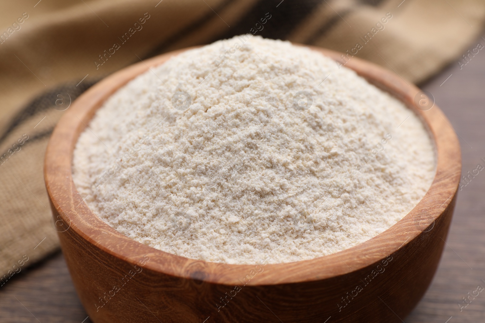 Photo of Quinoa flour in bowl on table, closeup