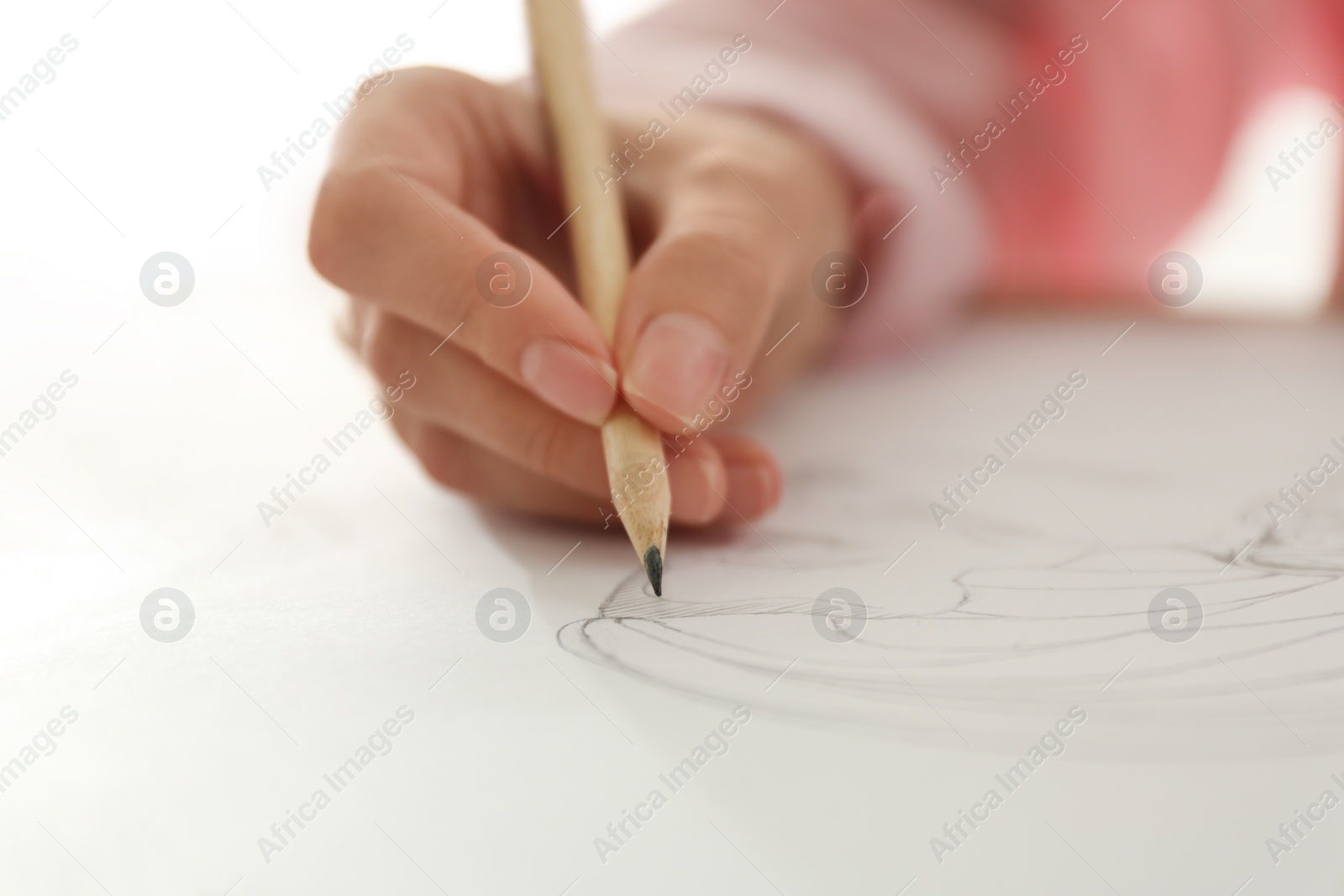 Photo of Woman drawing girl's portrait with pencil on sheet of paper, closeup