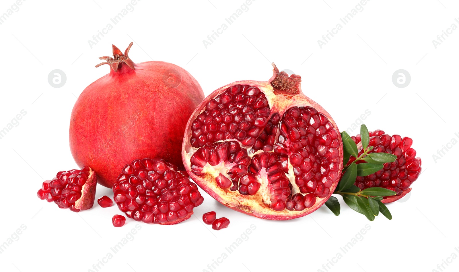 Photo of Fresh pomegranates and branches isolated on white