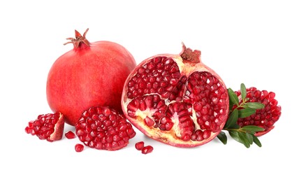 Fresh pomegranates and branches isolated on white