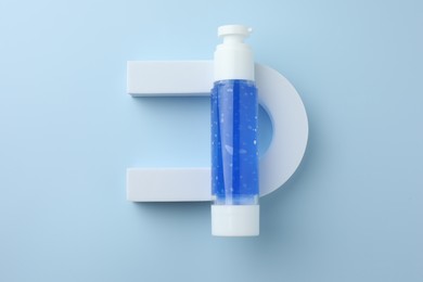 Photo of Cosmetic product on light blue background, top view