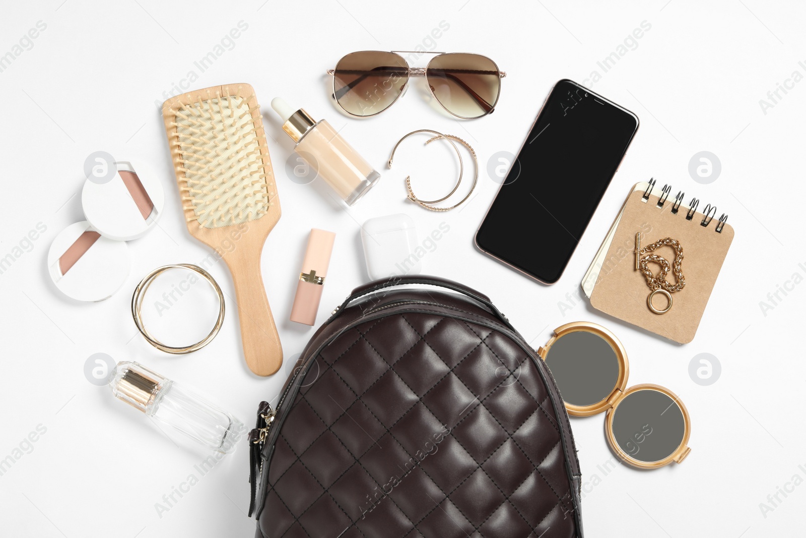 Photo of Stylish urban backpack with different items on white background, flat lay