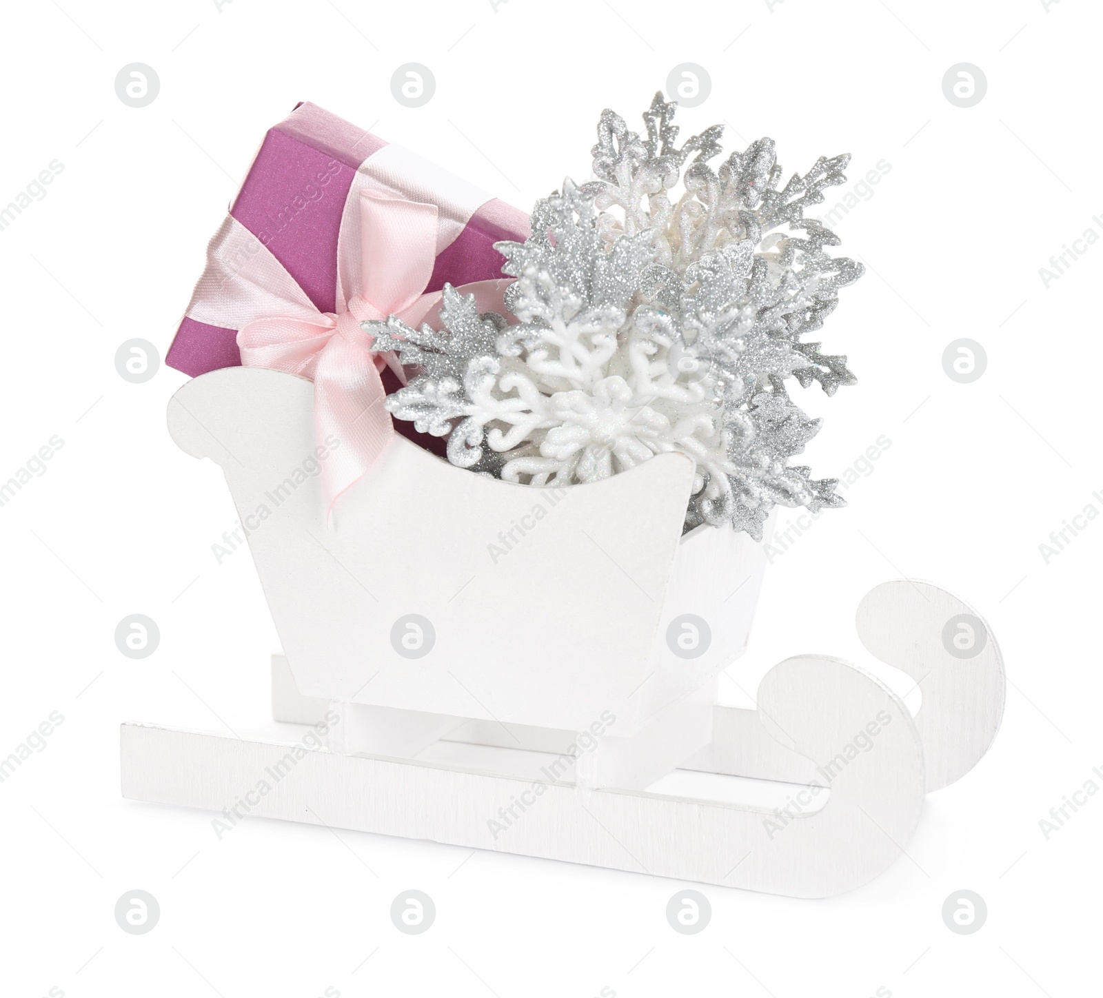 Photo of Wooden sleigh with present and Christmas decor on white background