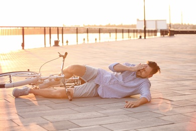 Man fallen off his bicycle on street