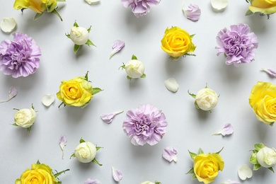 Photo of Flat lay composition with beautiful blooming flowers on grey background