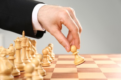 Photo of Man moving chess piece on board, closeup
