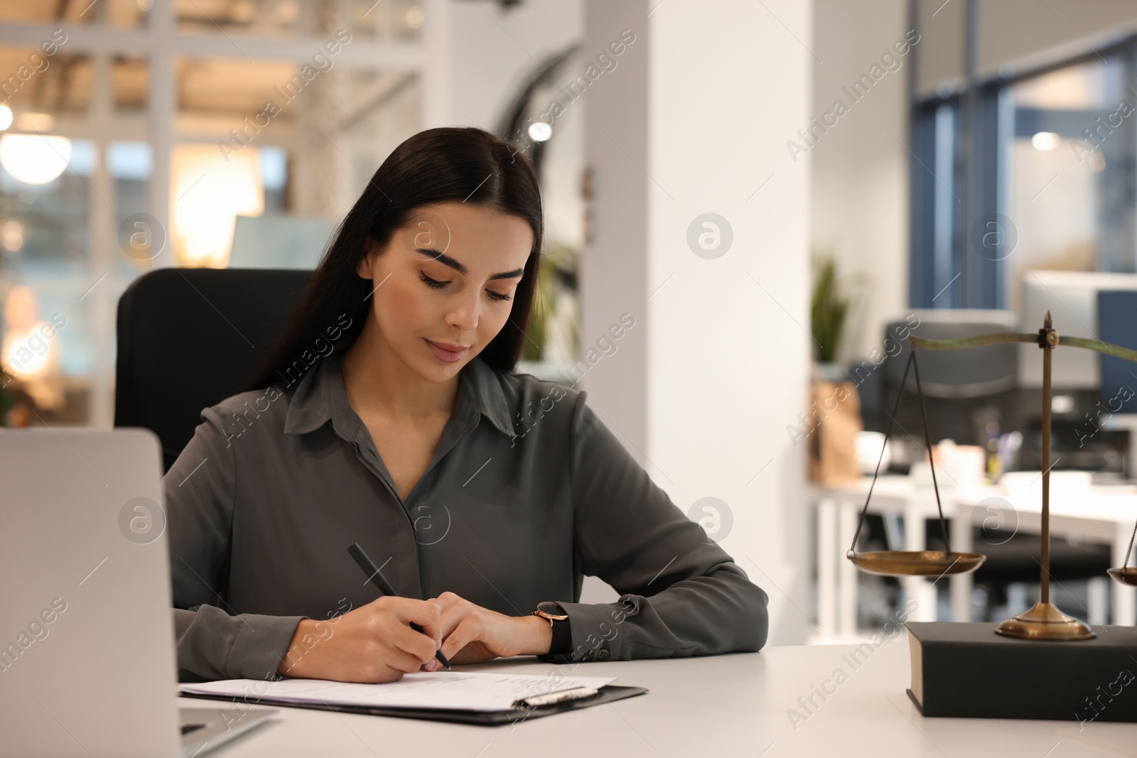 Photo of Portrait of confident lawyer working at table in office