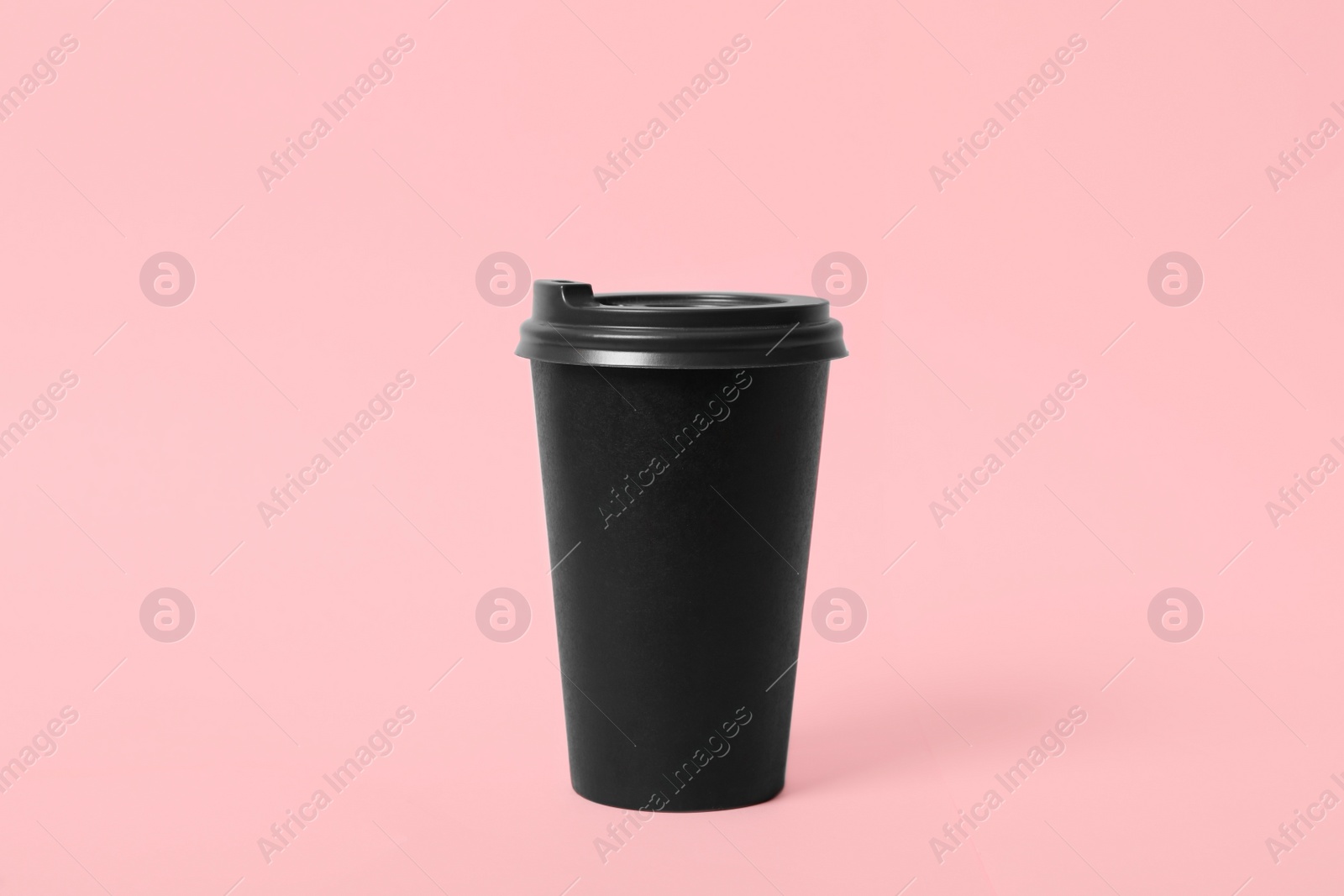 Photo of Takeaway paper coffee cup on pink background