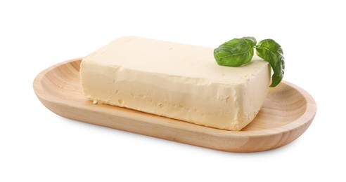 Photo of Block of tasty butter with basil isolated on white