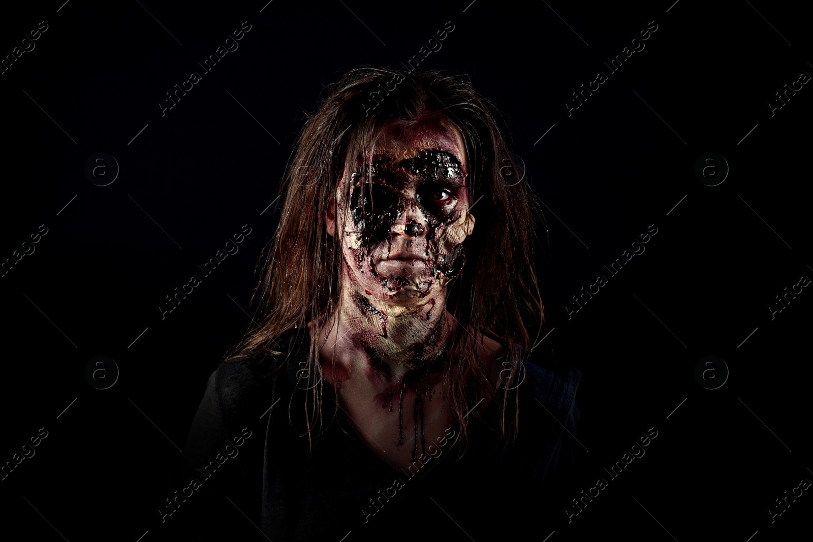 Photo of Scary zombie on dark background. Halloween monster