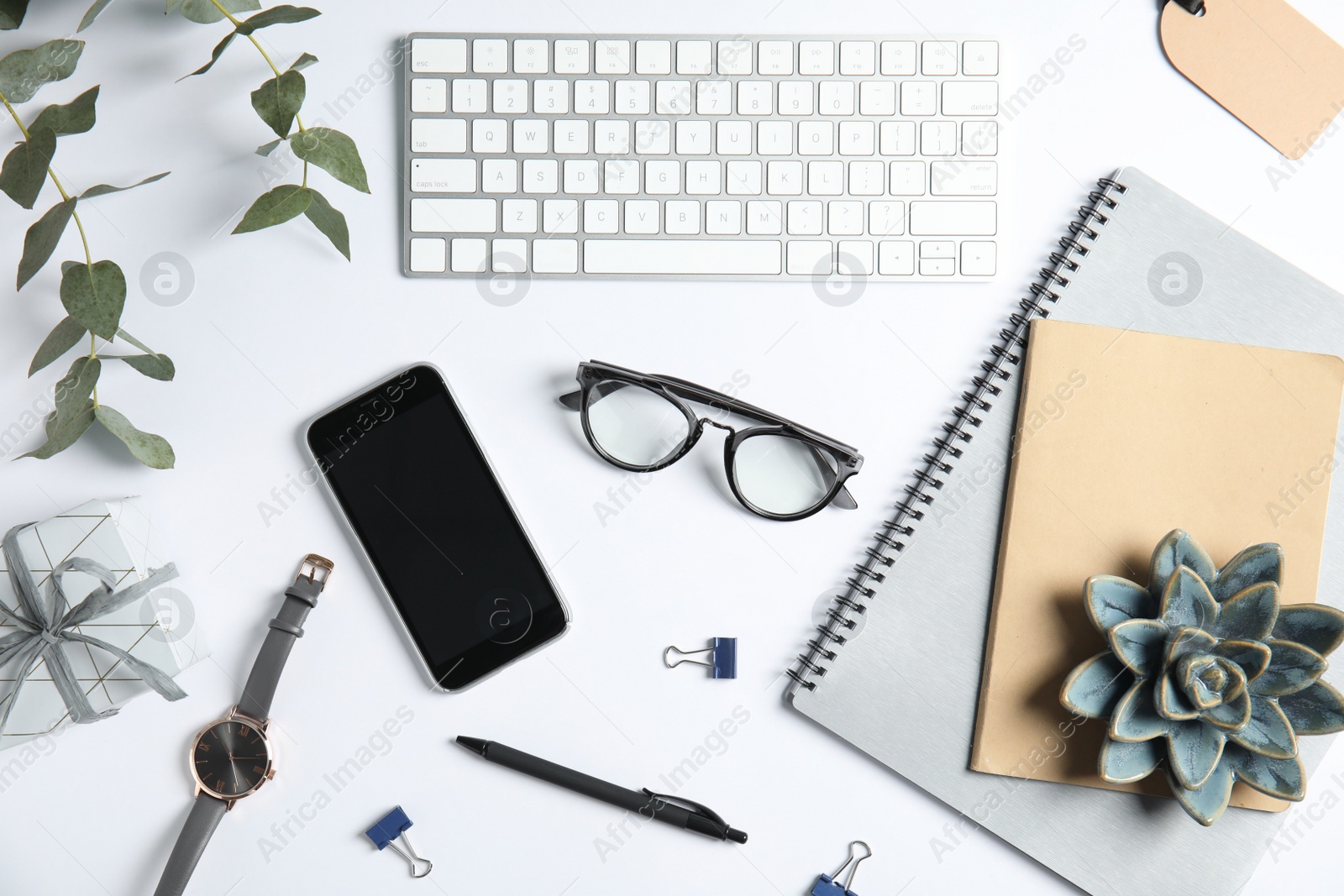 Photo of Flat lay composition with computer keyboard and mobile phone on white background. Blogger's workplace