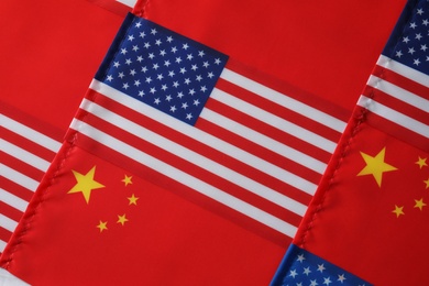 Photo of USA and China flags as background, top view. International relations