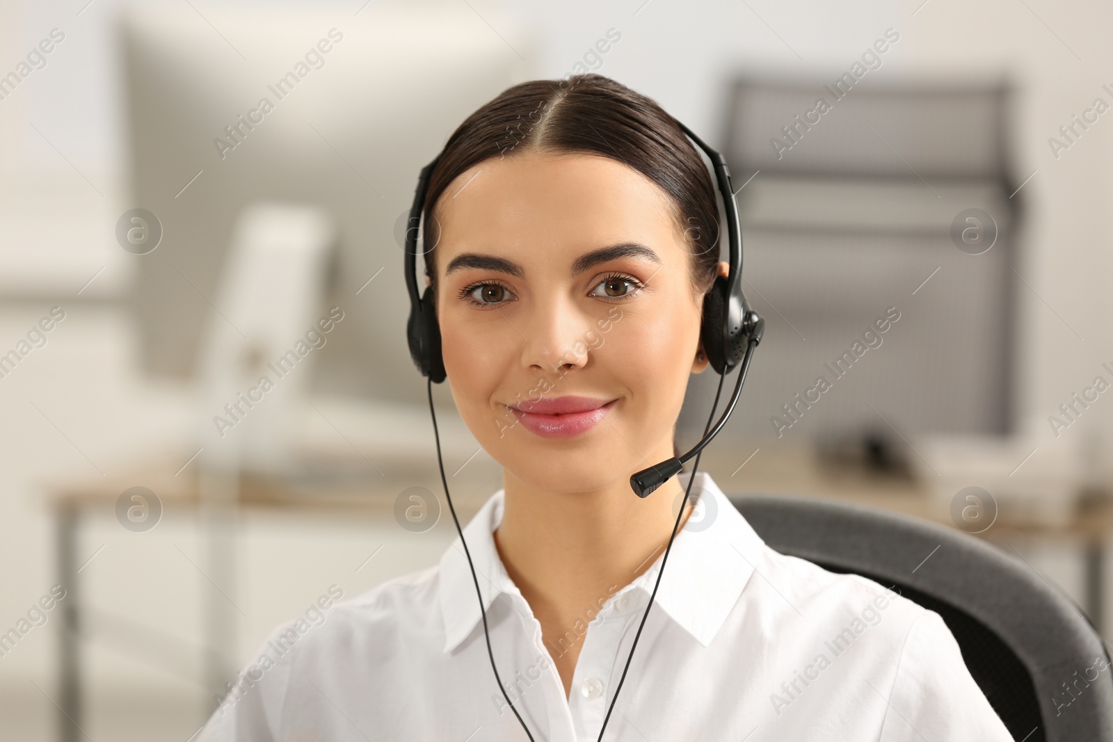 Photo of Hotline operator with headset working in office