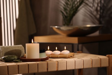 Beautiful composition with different spa products on wicker bench indoors