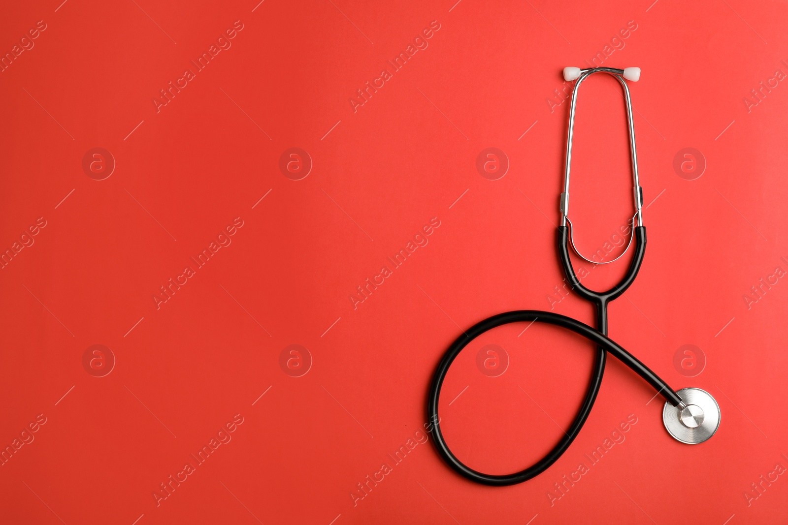 Photo of Top view of stethoscope and space for text on color background. Medical tool