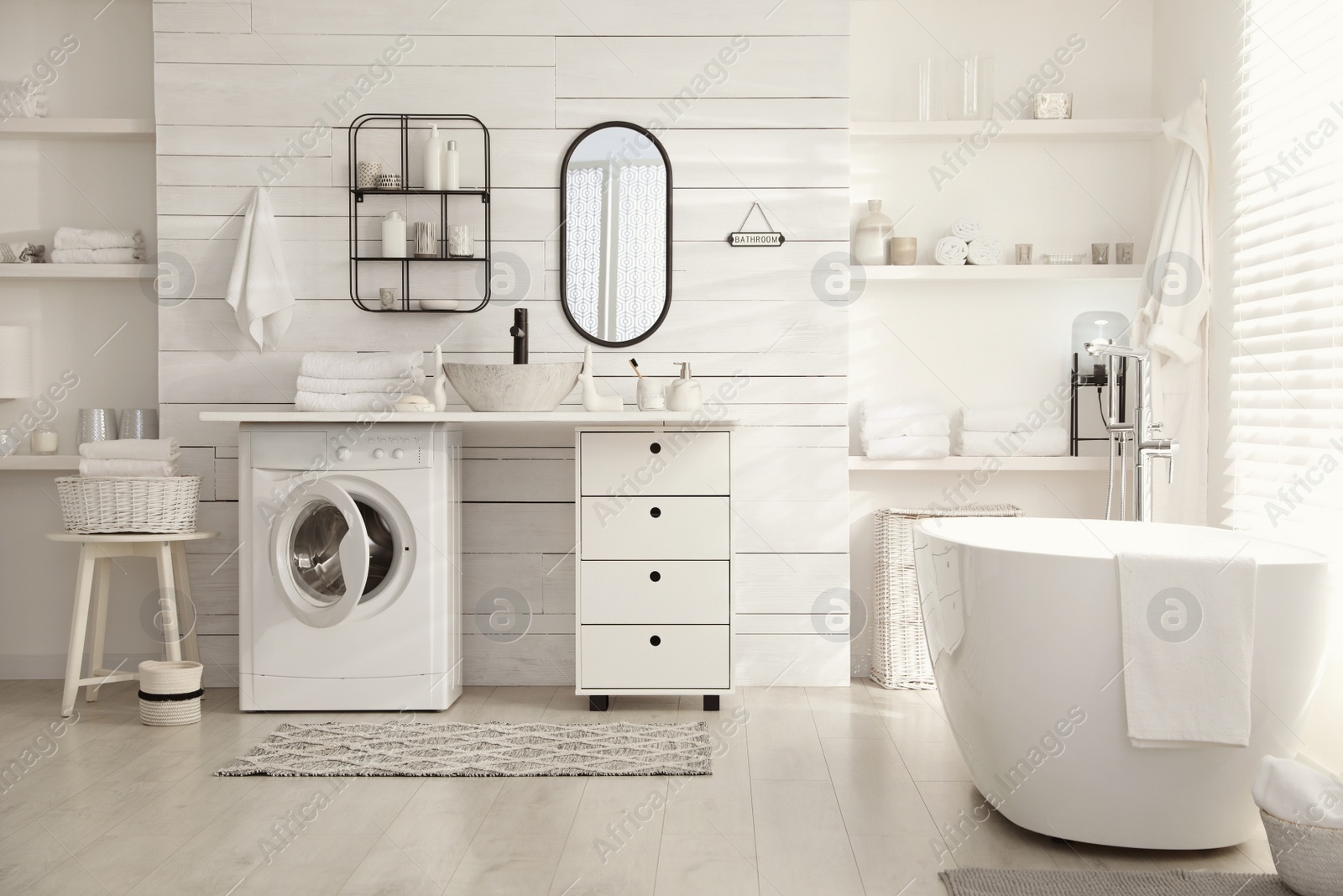 Photo of Stylish bathroom interior with modern washing machine