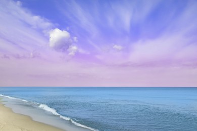 Image of Fantastic blue pink sky over ocean and sandy beach