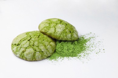 Photo of Tasty matcha cookies and powder on white background