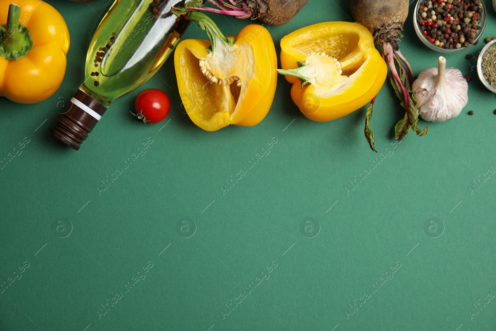 Photo of Flat lay composition with ingredients for cooking on green background. Space for text