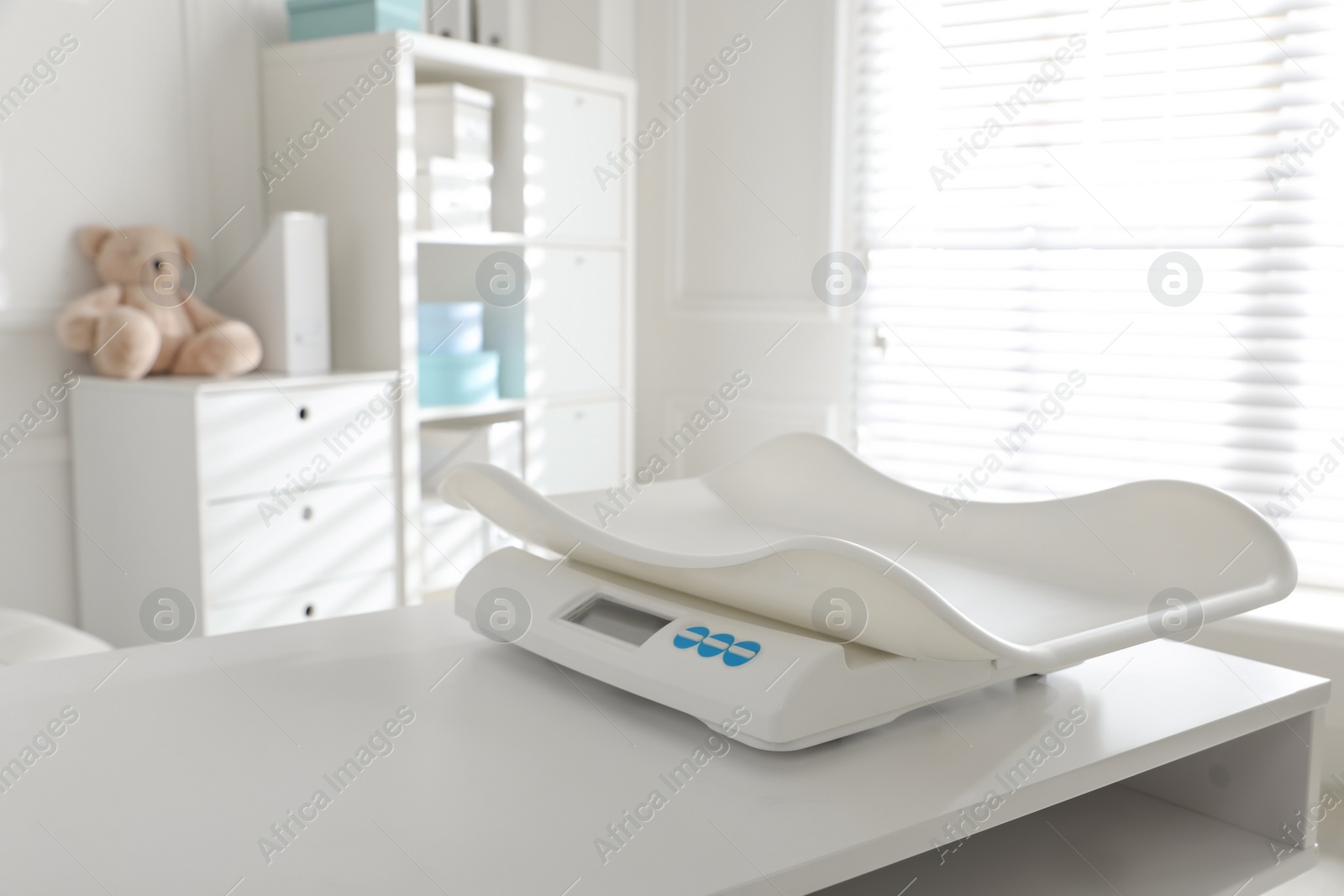 Photo of Modern digital baby scales on table in clinic