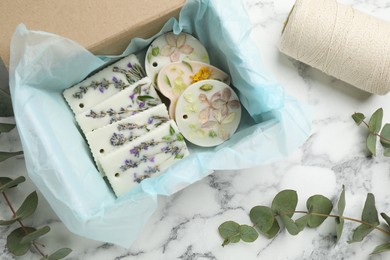 Flat lay composition with scented sachets on white marble table