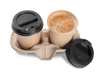 Takeaway paper cups with coffee in cardboard holder on white background