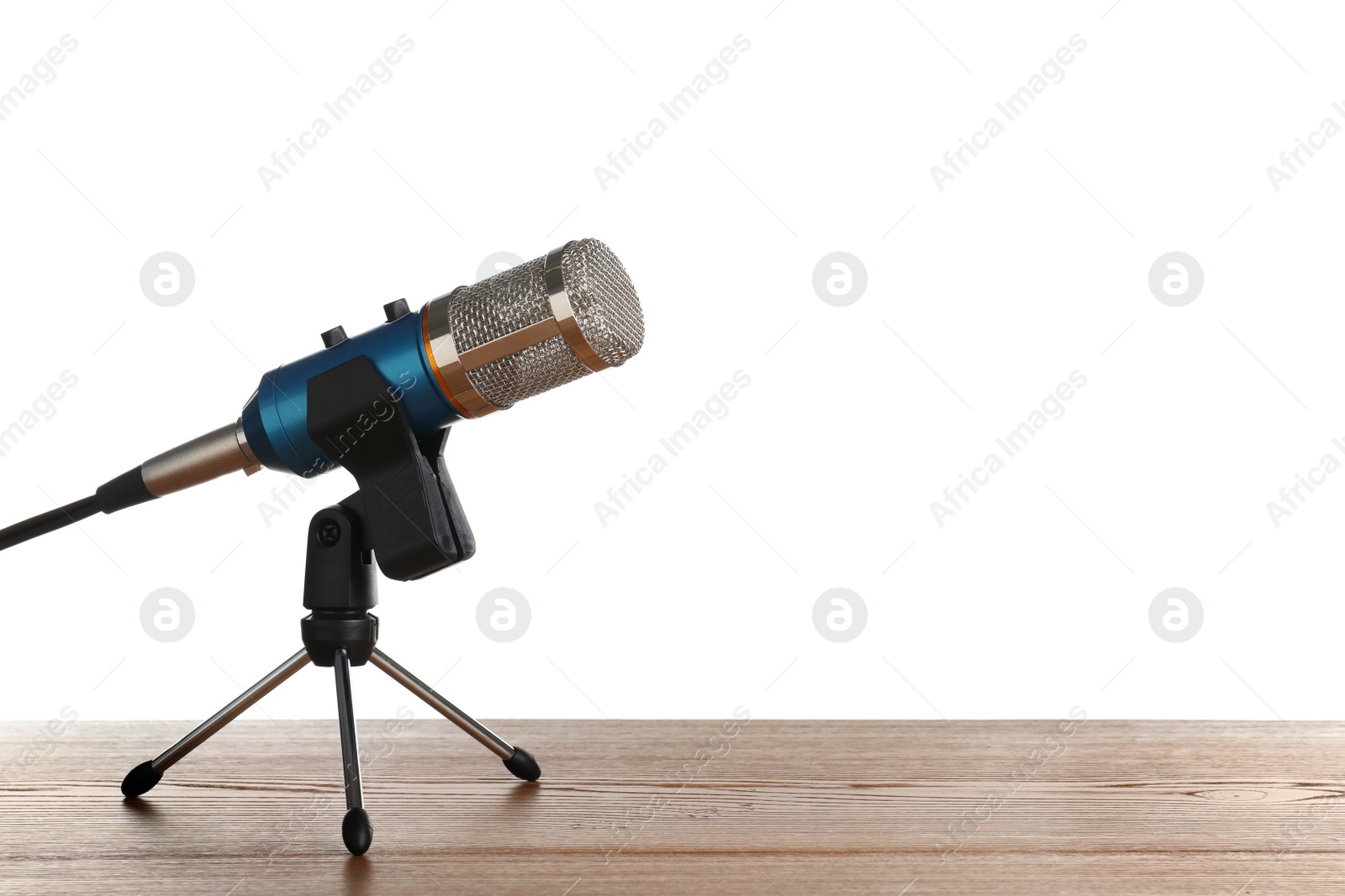 Photo of Microphone on table against white background. Space for text