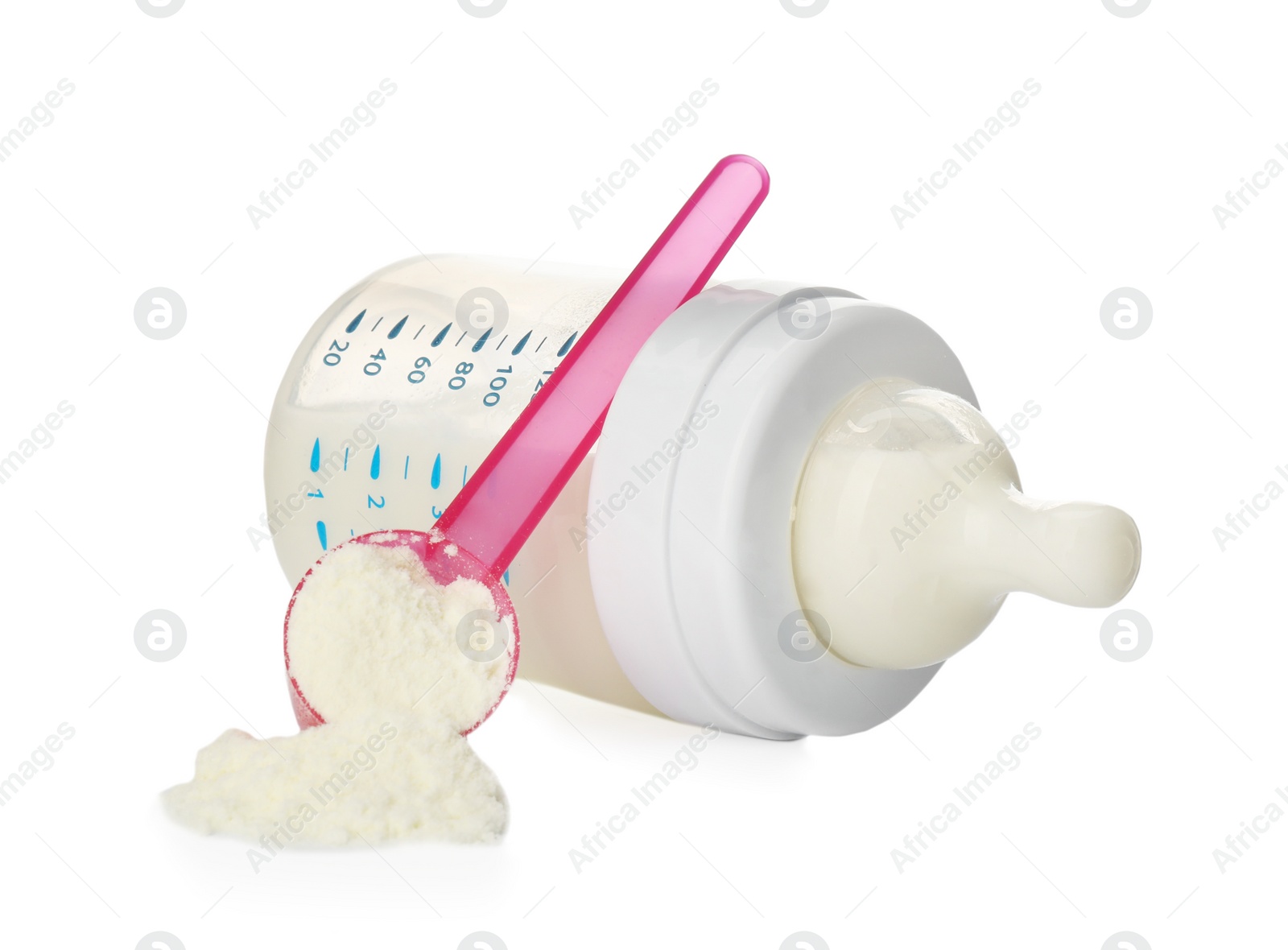 Photo of Feeding bottle with infant formula and scoop of powder on white background. Baby milk